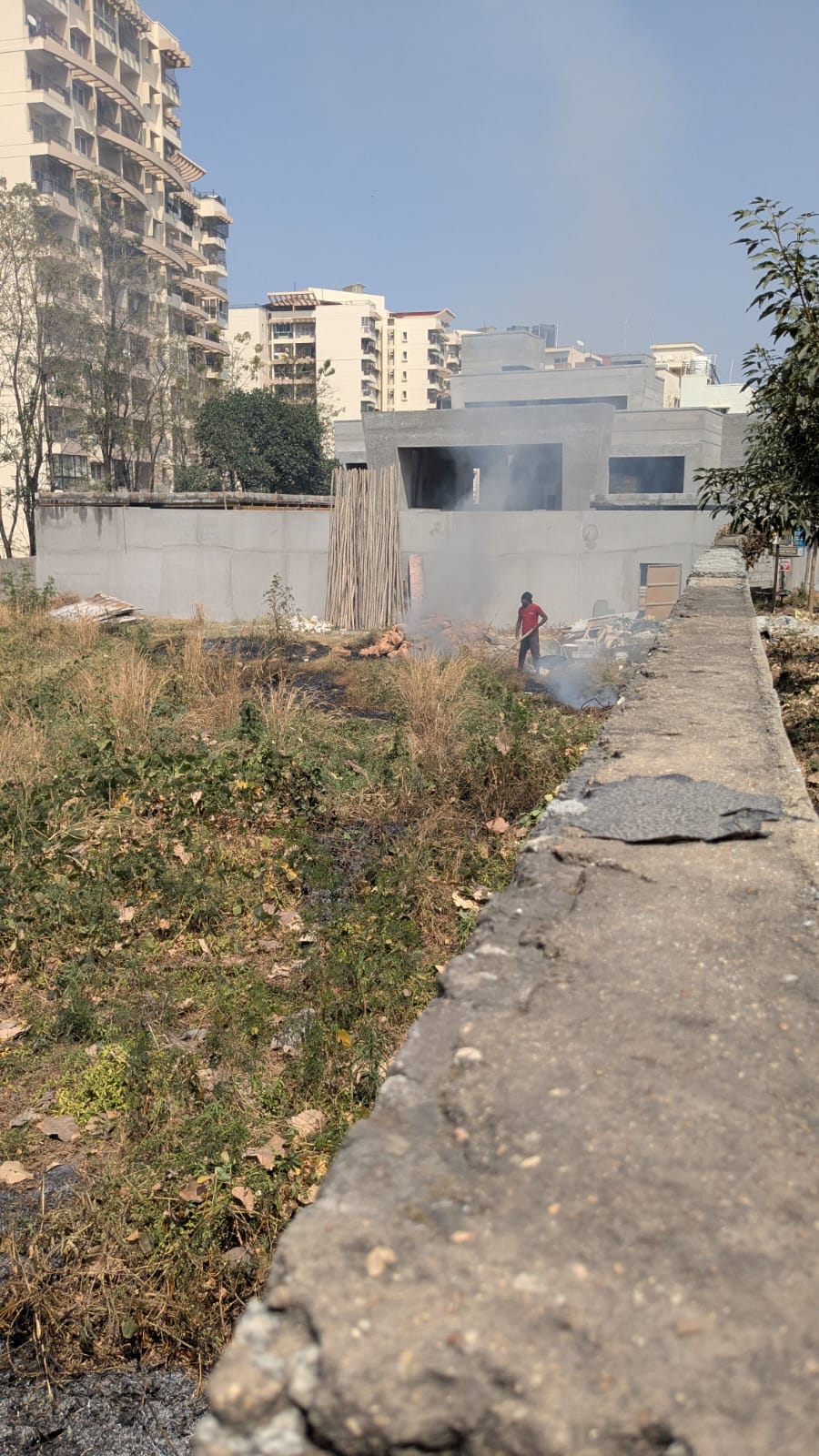 Person burning trash and stubble near Mantri Tranquil 2
